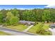 An aerial shot shows the brick home, its long driveway and the lawn with mature trees at 5033 Brantwood Dr., Mullins, SC 29574