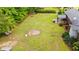 Large backyard featuring mature trees, a basketball hoop, storage building, and a covered patio at 5033 Brantwood Dr., Mullins, SC 29574