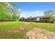 Brick home featuring a large backyard with covered pergola and mature landscaping at 5033 Brantwood Dr., Mullins, SC 29574