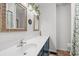 Well-lit bathroom features a long vanity with double mirrors and leafy decor at 5033 Brantwood Dr., Mullins, SC 29574