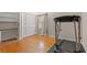 Bright bedroom features hardwood floors, a window, and a treadmill ready for workouts at 5033 Brantwood Dr., Mullins, SC 29574