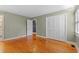 Bedroom with hardwood floors, closet, and access to the ensuite bathroom at 5033 Brantwood Dr., Mullins, SC 29574