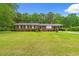 All brick ranch style home featuring manicured landscaping and a welcoming front porch at 5033 Brantwood Dr., Mullins, SC 29574