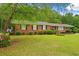 All brick ranch style home featuring manicured landscaping and a welcoming front porch at 5033 Brantwood Dr., Mullins, SC 29574