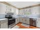 Well-lit kitchen featuring bright white cabinets, modern stainless appliances, and durable countertops at 5033 Brantwood Dr., Mullins, SC 29574