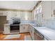 Bright kitchen featuring white cabinets, stainless steel appliances, and wood flooring at 5033 Brantwood Dr., Mullins, SC 29574