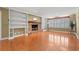 Bright living room featuring wood floors, a brick fireplace, and built-in shelving at 5033 Brantwood Dr., Mullins, SC 29574
