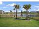 Well-manicured backyard featuring palm trees, an ornamental pond and lush green grass at 5039 Gladstone Dr, Conway, SC 29526