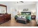 Spacious bedroom with hardwood floors, dresser, and calming green and white decor at 5039 Gladstone Dr, Conway, SC 29526
