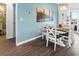 Bright dining area with wood table and flooring, leading to laundry area and backyard access at 5039 Gladstone Dr, Conway, SC 29526