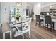 Bright dining area with wood floors, stylish lighting, and view of outdoor patio and backyard at 5039 Gladstone Dr, Conway, SC 29526