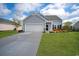 Charming single-Gathering home featuring a well-manicured lawn, attached garage, and beautiful curb appeal at 5039 Gladstone Dr, Conway, SC 29526