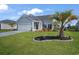 Charming single-Gathering home featuring a well-manicured lawn, attached garage, and beautiful curb appeal at 5039 Gladstone Dr, Conway, SC 29526