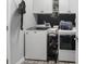 Modern laundry room with updated machines, black and white accent wall, and patterned tile flooring at 5039 Gladstone Dr, Conway, SC 29526