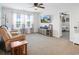 A bright living room with a plush sofa, ceiling fan, and a media console at 5039 Gladstone Dr, Conway, SC 29526