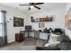 A functional office with dark walls, plush carpet, and an L shaped desk and wall shelving at 5039 Gladstone Dr, Conway, SC 29526