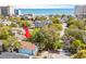 Aerial view showcases a home surrounded by trees, with an arrow pointing to the property at 504 A S 19Th Ave. S, North Myrtle Beach, SC 29582