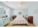 Comfortable bedroom with a floral quilt, a blue dresser, and neutral carpeting at 504 A S 19Th Ave. S, North Myrtle Beach, SC 29582