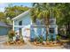 Charming two-story home with a light blue exterior, palm tree, and beautiful landscaping at 504 A S 19Th Ave. S, North Myrtle Beach, SC 29582