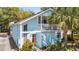 Charming two-story home with a light blue exterior, balcony, and a well-manicured yard at 504 A S 19Th Ave. S, North Myrtle Beach, SC 29582