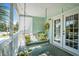 This covered porch features a porch swing, a ceiling light, a small flower arrangement, and a view of the sky at 504 A S 19Th Ave. S, North Myrtle Beach, SC 29582