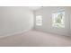 Cozy bedroom with two windows, neutral carpet, and freshly painted walls at 512 Charlton Blvd., Georgetown, SC 29440