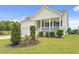 Exterior view of a charming home, showing well-manicured landscaping and a side porch at 512 Charlton Blvd., Georgetown, SC 29440