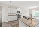 Well-lit kitchen with granite countertops, stainless steel appliances, and an island with a sink at 512 Charlton Blvd., Georgetown, SC 29440