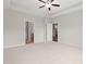 Spacious bedroom with carpet, ceiling fan, and ensuite bathroom with views of the kitchen at 512 Charlton Blvd., Georgetown, SC 29440
