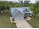 Aerial view of charming home with a two-car garage, metal roof, and a long driveway at 521 Oak Lawn Rd., Georgetown, SC 29440