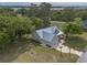 Gorgeous home with a metal roof on a sprawling lot near the water, surrounded by mature trees and lush landscaping at 521 Oak Lawn Rd., Georgetown, SC 29440