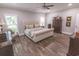 Large primary bedroom with dark stained floors and windows at 521 Oak Lawn Rd., Georgetown, SC 29440