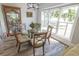 Cozy breakfast nook with a round glass table, four chairs, and a large window with a view at 521 Oak Lawn Rd., Georgetown, SC 29440