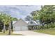 Beautiful home featuring a metal roof, a two-car garage, and a welcoming front porch, surrounded by lush trees at 521 Oak Lawn Rd., Georgetown, SC 29440