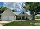 Charming home featuring a metal roof, a two-car garage, and a welcoming front porch perfect for relaxing at 521 Oak Lawn Rd., Georgetown, SC 29440