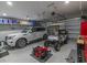 Organized garage featuring a car, golf cart, lawn mower, and ample storage space at 521 Oak Lawn Rd., Georgetown, SC 29440