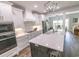 Modern kitchen with white cabinets, a marble countertop island, and stainless steel appliances at 521 Oak Lawn Rd., Georgetown, SC 29440