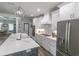 Bright kitchen featuring a white marble countertop, a stainless steel refrigerator, and white cabinets at 521 Oak Lawn Rd., Georgetown, SC 29440
