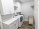 Well-organized laundry room featuring white cabinetry, countertop space, and modern appliances at 521 Oak Lawn Rd., Georgetown, SC 29440