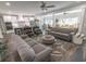 Bright living room featuring a grey sofa, leather chairs, and an open-concept design into the kitchen at 521 Oak Lawn Rd., Georgetown, SC 29440