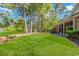 Lush backyard with manicured lawn and mature trees, ideal for enjoying outdoor activities at 5647 S Blackmoor Dr., Murrells Inlet, SC 29576