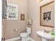 Cozy powder room with pedestal sink, decorative mirror, and neutral color scheme at 5647 S Blackmoor Dr., Murrells Inlet, SC 29576