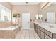 Elegant bathroom with a soaking tub, double vanity, and a large mirror offering lots of space at 5647 S Blackmoor Dr., Murrells Inlet, SC 29576