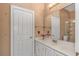 Elegant bathroom with bright vanity, fresh flowers, and decorative finishes at 5647 S Blackmoor Dr., Murrells Inlet, SC 29576