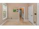 Large, bright bedroom featuring mounted television and doorway to bathroom at 5647 S Blackmoor Dr., Murrells Inlet, SC 29576