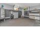 Spacious garage with storage cabinets, sink, and a wall-mounted television for entertainment and convenience at 5647 S Blackmoor Dr., Murrells Inlet, SC 29576