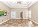 Bright living room with trey ceiling, tile floors, and a TV, creating a cozy and stylish atmosphere at 5647 S Blackmoor Dr., Murrells Inlet, SC 29576