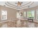 Inviting living room featuring a trey ceiling, tile flooring, and large windows offering scenic views at 5647 S Blackmoor Dr., Murrells Inlet, SC 29576