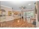 Spacious living room with hardwood floors, large windows, and an open layout, offering a bright and airy atmosphere at 5647 S Blackmoor Dr., Murrells Inlet, SC 29576