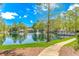 Scenic view of a serene pond with a water fountain and gazebo in a community at 5647 S Blackmoor Dr., Murrells Inlet, SC 29576